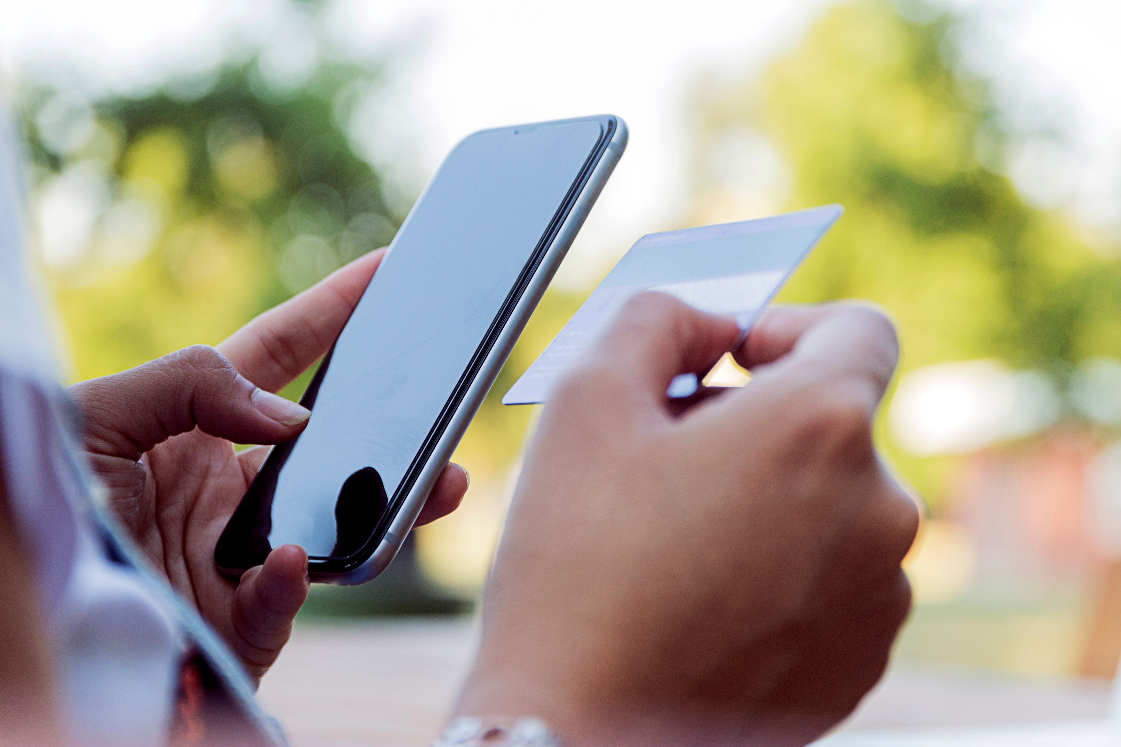 Hands Holding Phone and Card